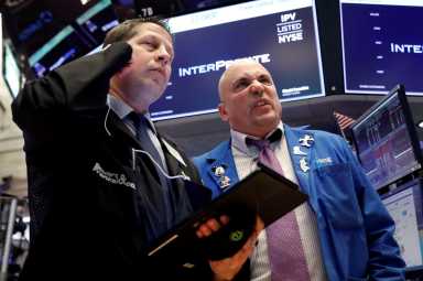 Traders work on the floor of the New York Stock Exchange (NYSE) in New York