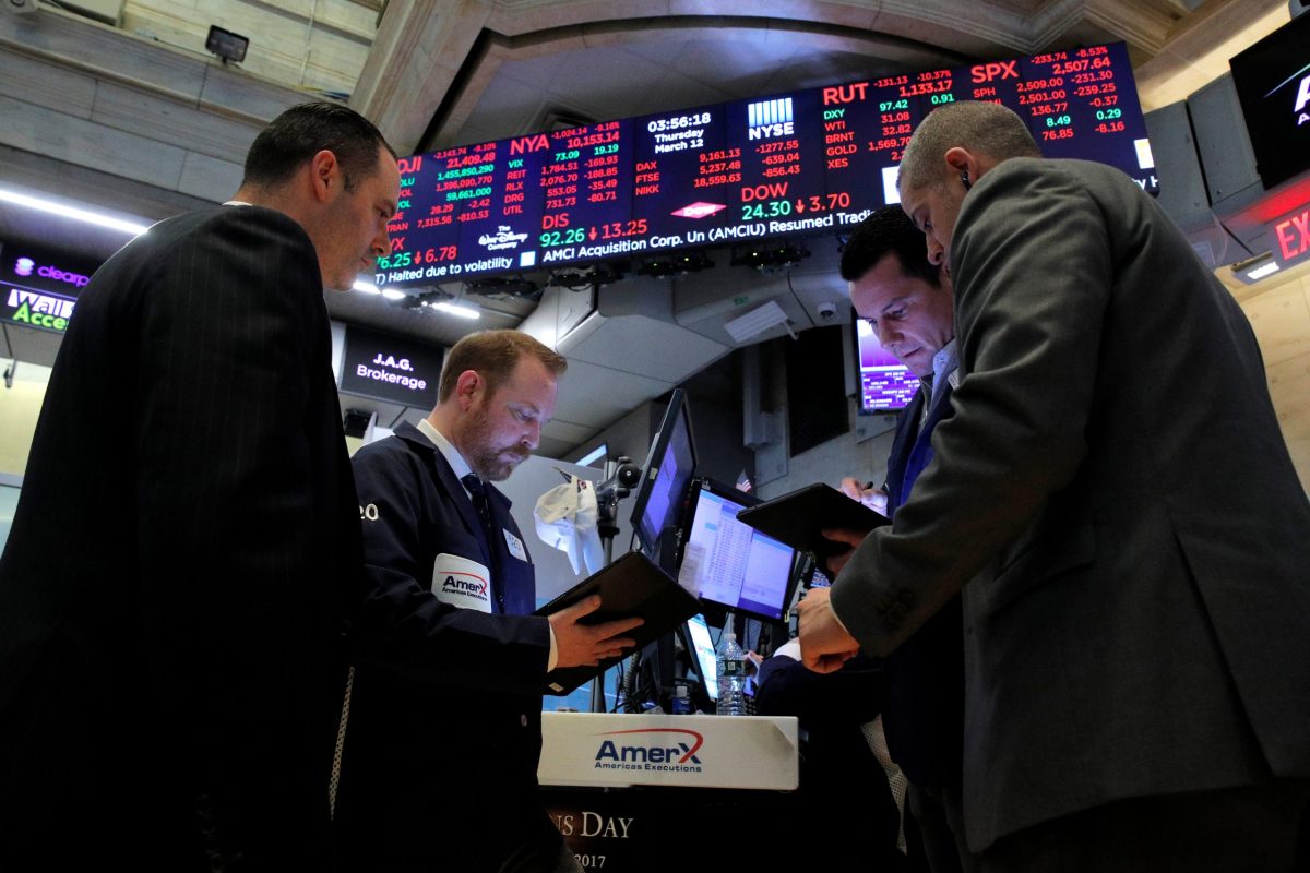 Traders on the floor of the New York Stock Exchange (NYSE) near the close of trading in New York