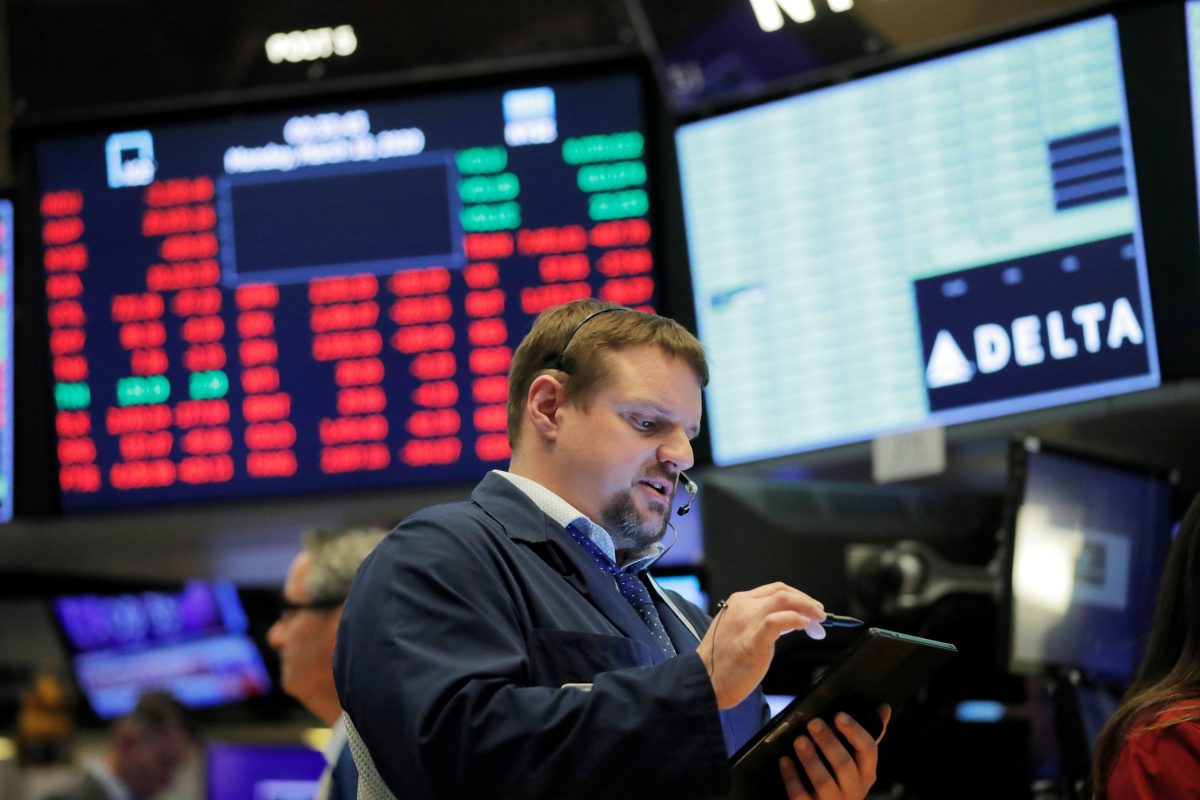 Traders work on the floor of the New York Stock Exchange shortly after the opening bell as trading is halted in New York
