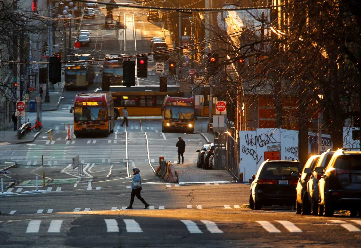 A person crosses the street in the International District-Chinatown neighborhood during the outbreak of coronavirus disease (COVID-19), in Seattle