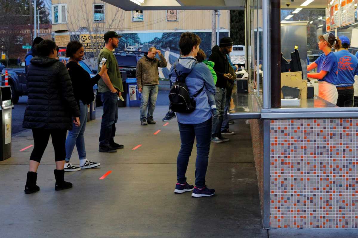 Lines on the ground help customers maintain safe social distance amid the coronavirus outbreak in Seattle