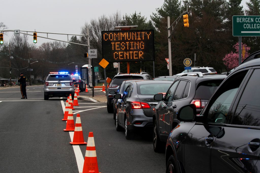 People wait in their cars for being tested at a new drive-thru coronavirus disease (COVID-19) testing center at Bergen Community College in Paramus, New Jersey
