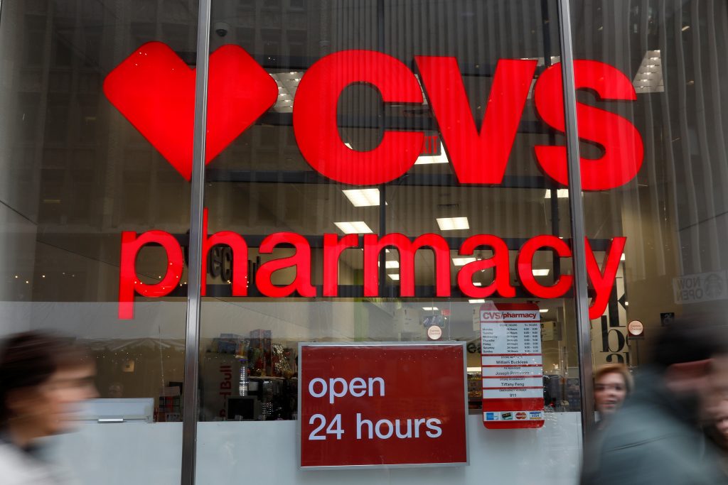People walk by a CVS Pharmacy store in the Manhattan borough of New York City
