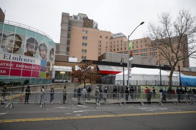 People wait in line to be tested for coronavirus disease (COVID-19) outside Elmhurst Hospital Center in the Queens borough of New York