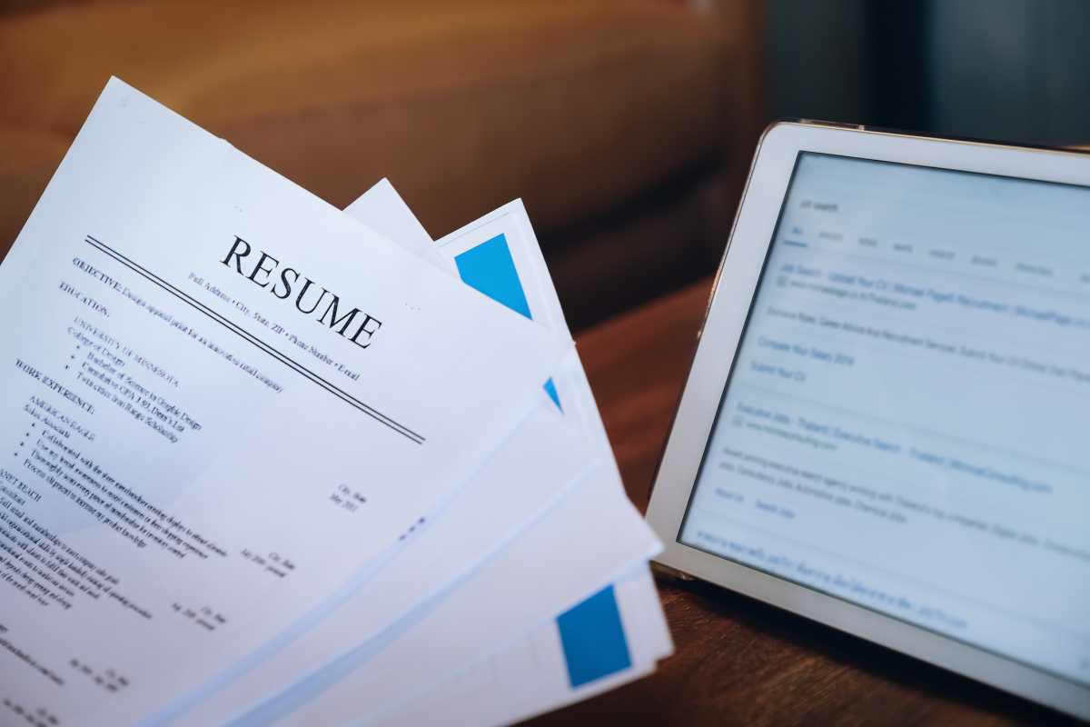 woman holding resume application with using tablet digital to job search on internet. applying for a job concept.