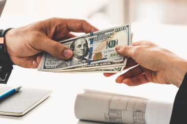 Transfer of money from hand to hand.