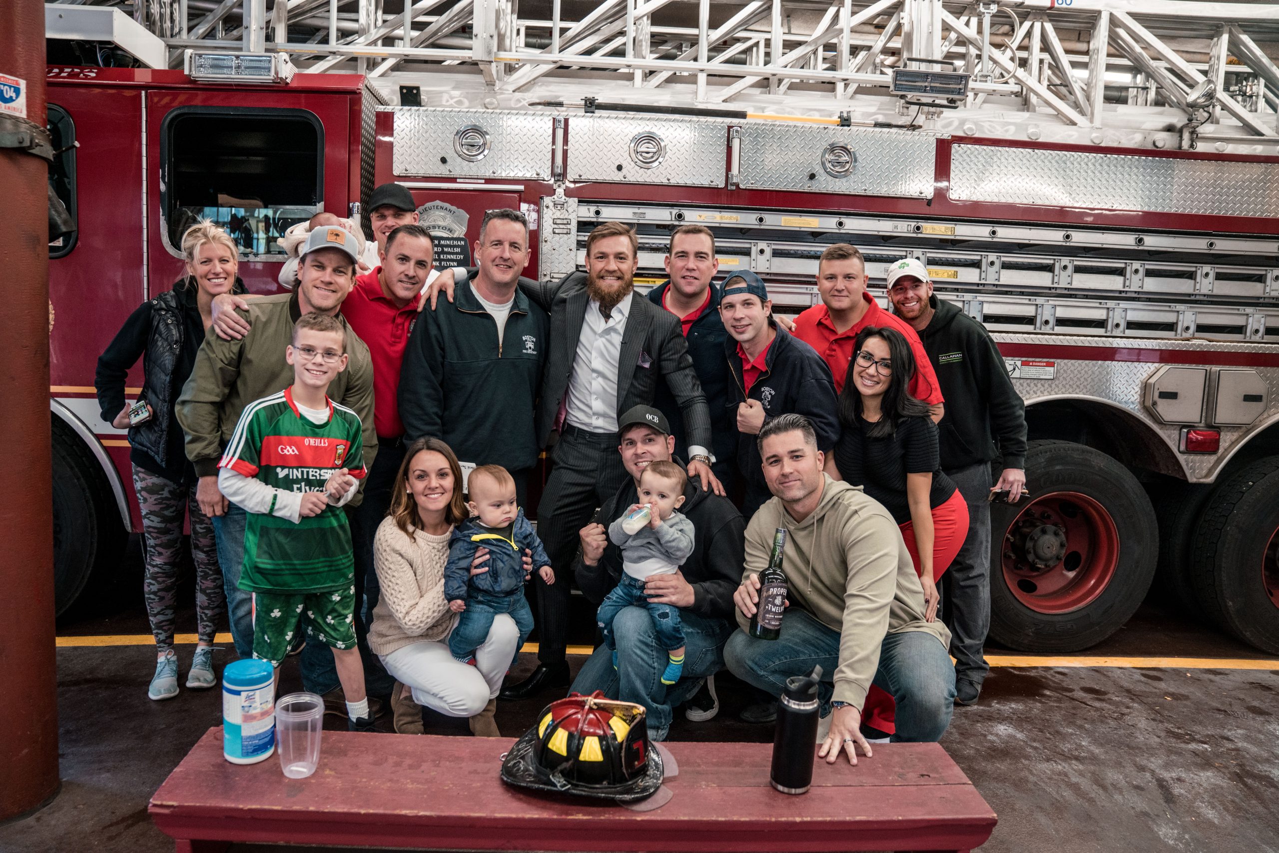 Conor McGregor with firefighters and families