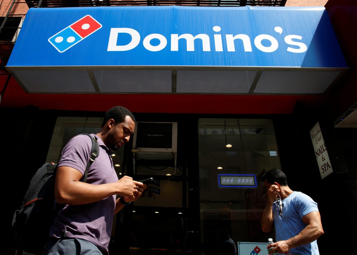 People pass by a Domino’s Pizza restaurant in New York