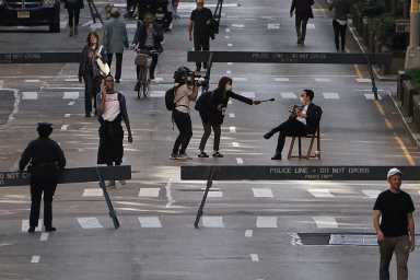 People walk on Park Avenue that was closed to vehicular traffic during the outbreak of coronavirus disease (COVID-19), in the Manhattan borough of New York City