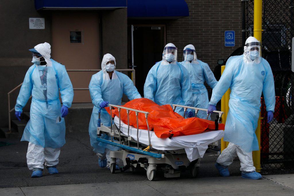 Healthcare workers wheel body of deceased person from Wyckoff Heights Medical Center during outbreak of coronavirus disease (COVID-19) in New York