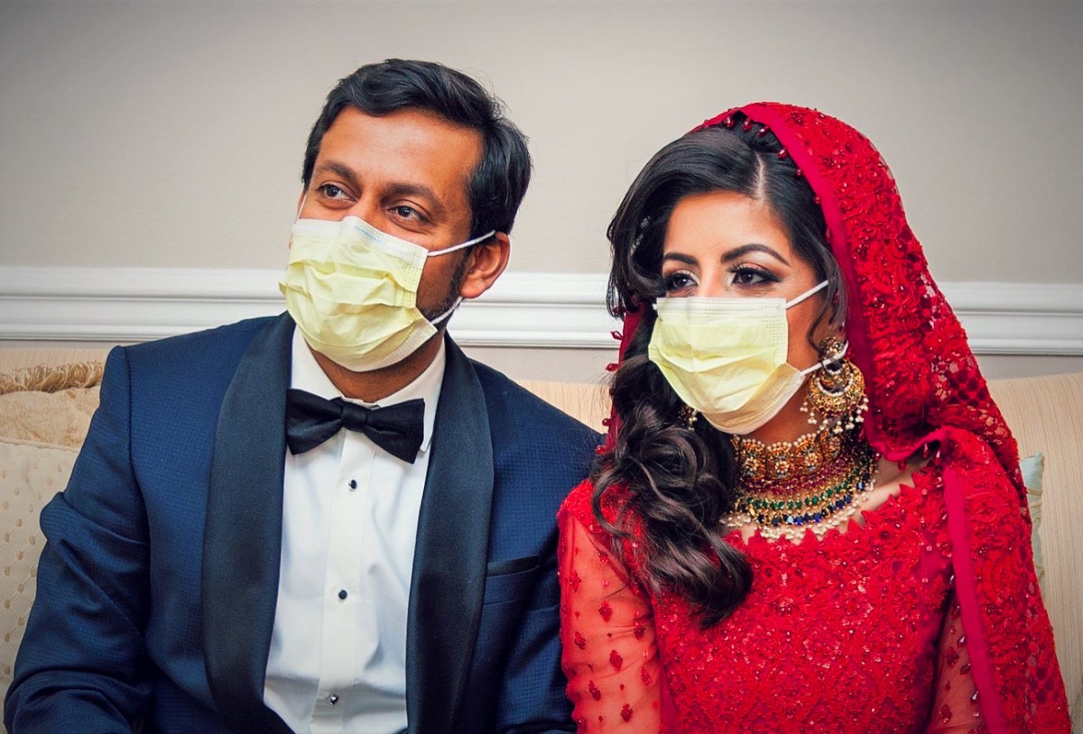 Doctors Kashif Chaudhry and Naila Shereen wear face masks after their wedding in New Windsor