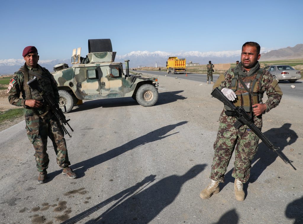 Afghan National Army (ANA) soldiers stand guard at a check point near the Bagram Airbase north of Kabul, Afghanistan