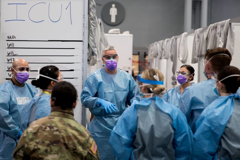 U.S. Army Major Sean Shirley holds a meeting with staff in the Javits New York Medical Station intensive care unit