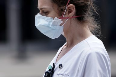 A registered nurse walks out of a hospital during the outbreak of Coronavirus disease (COVID-19), in the Manhattan borough of New York City