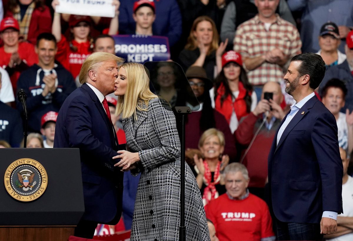 FILE PHOTO: U.S. President Donald Trump kisses Ivanka Trump as Donald Trump Jr. watches during a campaign rally in Manchester, New Hampshire