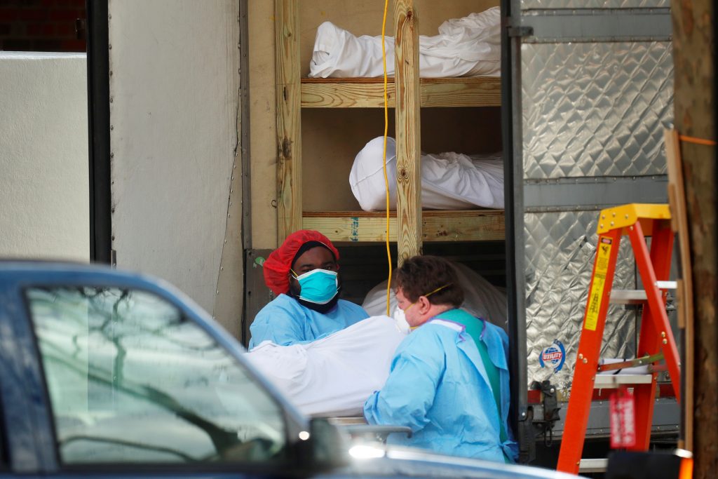 Healthcare workers transfer a body at Kingsbrook Jewish Medical Center in the Brooklyn borough of New York