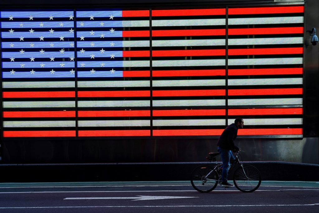 FILE PHOTO: A bicyclist rides through Times Square during evening rush hour in New York