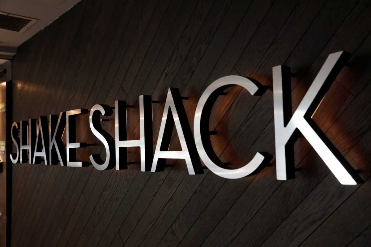 FILE PHOTO: A logo stands outside of a Shake Shack store in New York