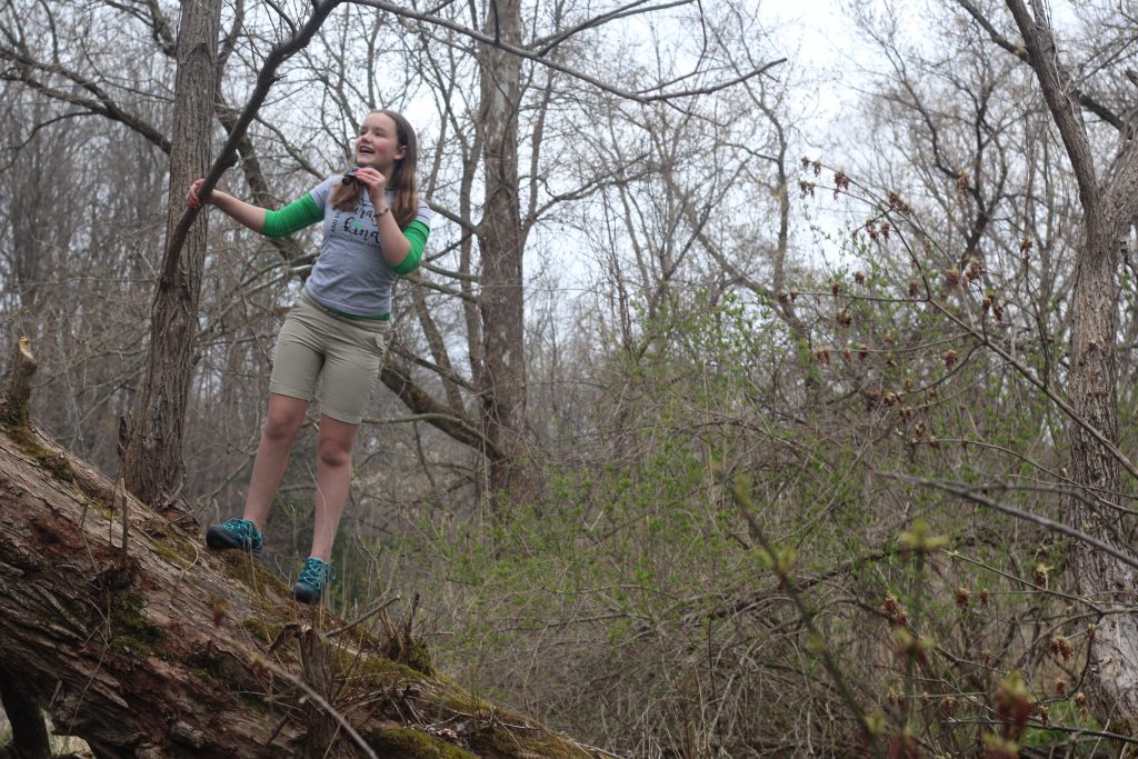 Jordan Miller, 11, birdwatches in her back yard in Manlius