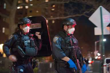 Members of ESU Truck 7 wear mask while doing a search of an apartment at 330 Dumont Avenue. One man was shot and killed.