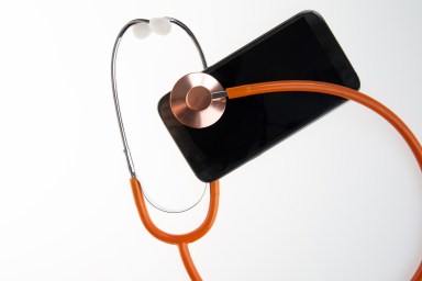 orange thin line stethoscope With Mobile Phone Isolated On White Background concept of advice