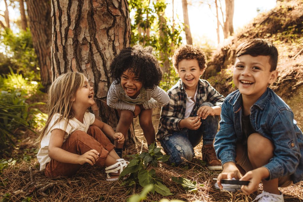 Group of cute kids playing in forest