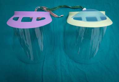 Twin plastic protective face shield preparing for use in operating room in hospital.