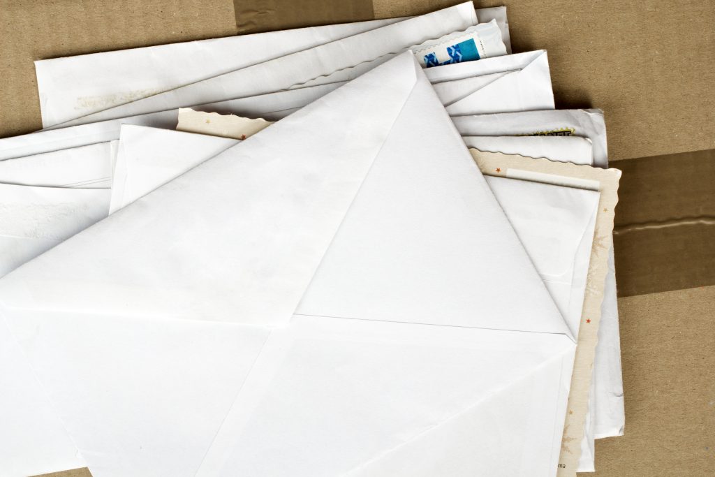 pile of letters and postal parcel