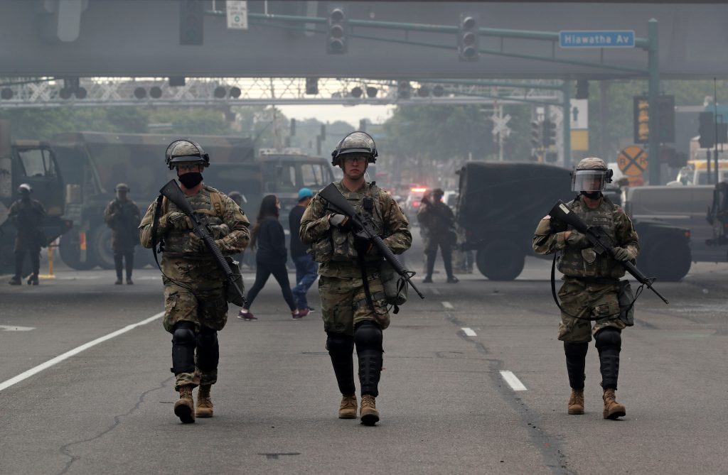 National Guard members walk at the area in the aftermath of a protest, in Minneapolis