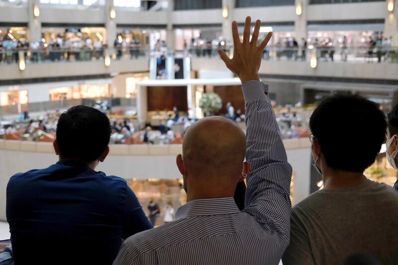 FILE PHOTO: A pro-democracy demonstrator raises his hand up as a symbol of the “Five demands, not one less” during a protest against Beijing’s plans to impose national security legislation in Hong Kong
