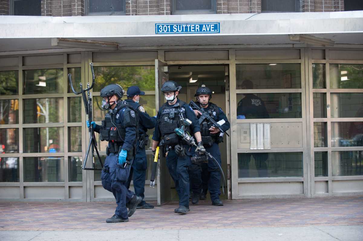Emergency Service Units get ready to check 14th floor for suspec