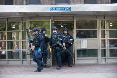 Emergency Service Units get ready to check 14th floor for suspec