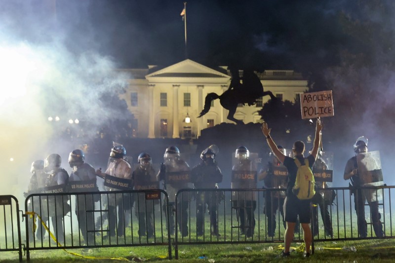 Police in riot gear keep protesters at bay in Lafayette Park near the White House in Washington