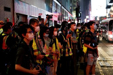 Journalists wearing yellow vests are seen during an anti-government protest to mock Chief Executive Carrie Lam at Mong Kok, in Hong Kong