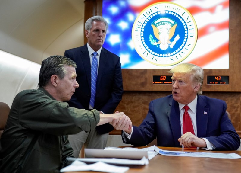 FILE PHOTO: U.S. President Donald Trump receives a briefing on Hurricane Dorian recovery efforts aboard Air Force One in Havelock, North Carolina