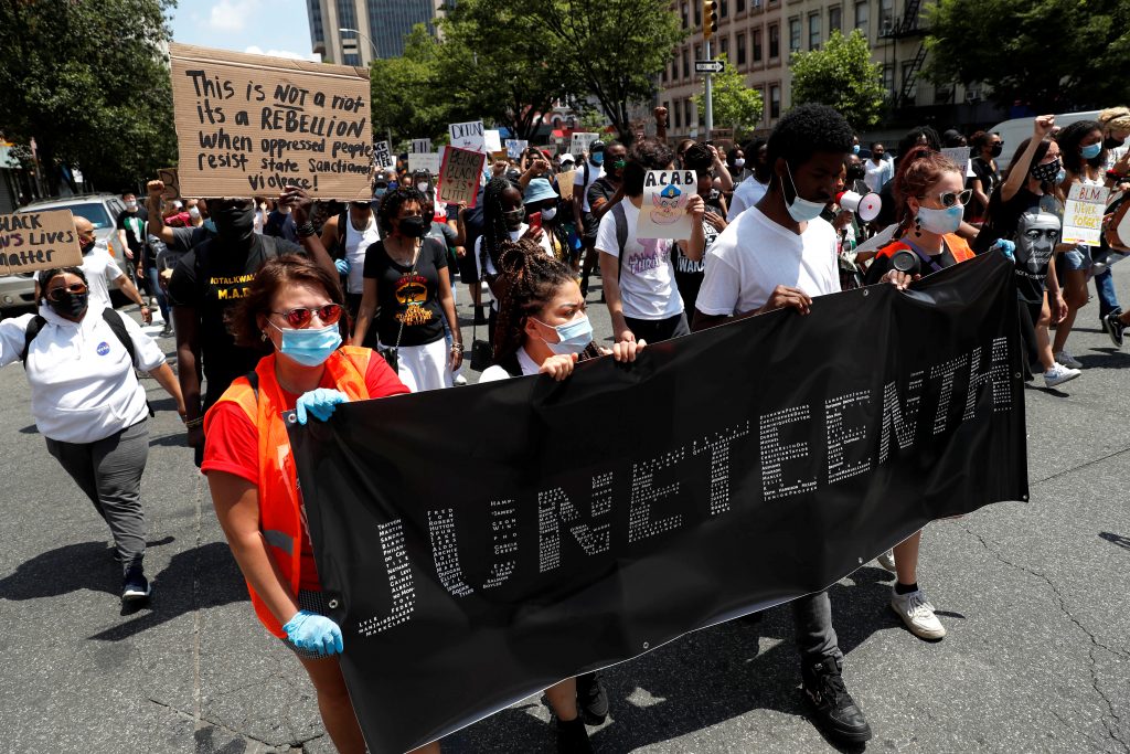 People take part in events to mark Juneteenth, which commemorates the end of slavery in Texas, in New York