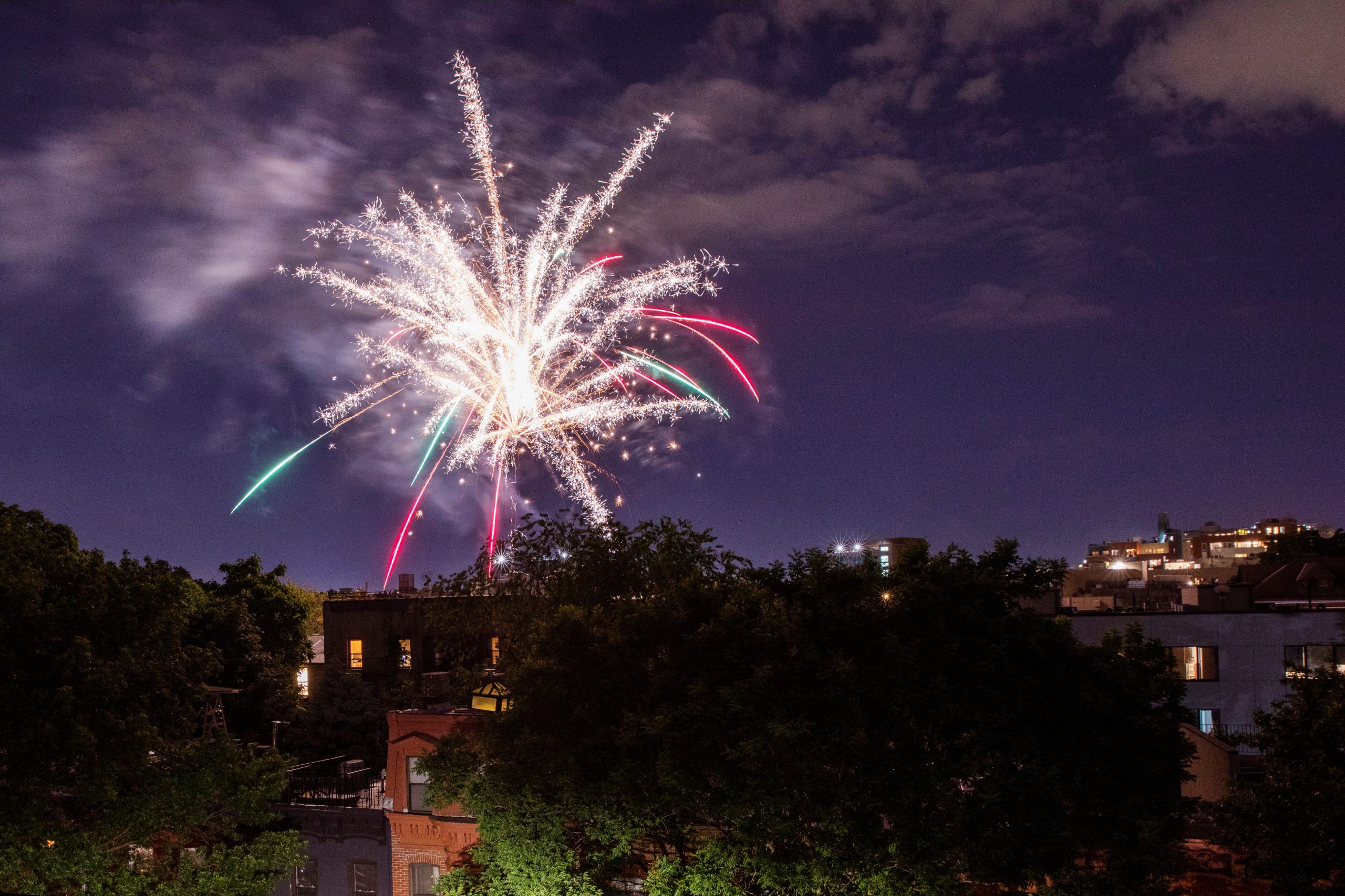 Illegal fireworks illuminate the sky over the Bedford-Stuyvesant neighborhood of the Brooklyn borough of New York City, New York