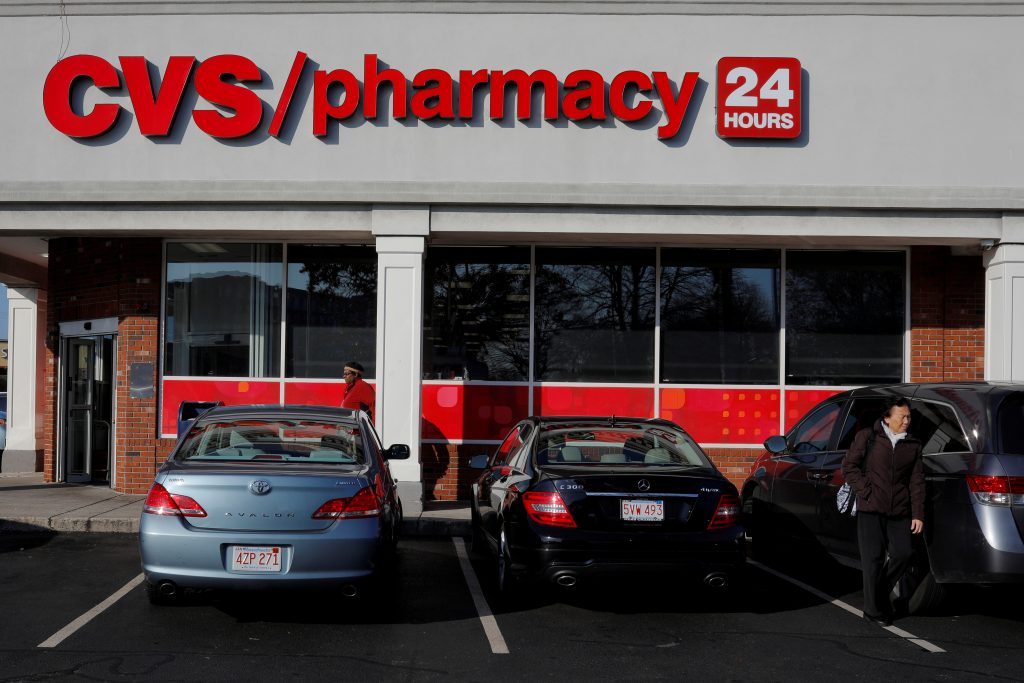 FILE PHOTO: Shoppers walk outside a CVS store and pharmacy in Medford