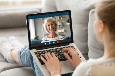 Millennial girl talk on video call with mature mother