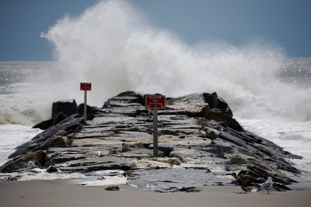 Waves hit rocks at Rockaway Beach in Queens, New York City on Labor Day where people surfed despite closures due to post-tropical cyclone Hermine