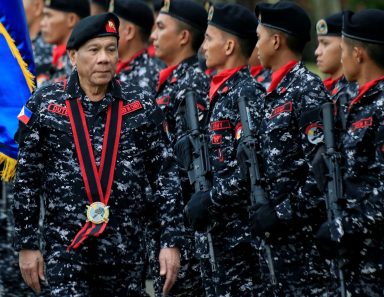 FILE PHOTO: Philippine President Rodrigo Duterte, wearing a military uniform, reviews scout ranger troops upon his arrival during the 67th founding anniversary of the First Scout Ranger regiment in San Miguel town, Bulacan province, north of Manila