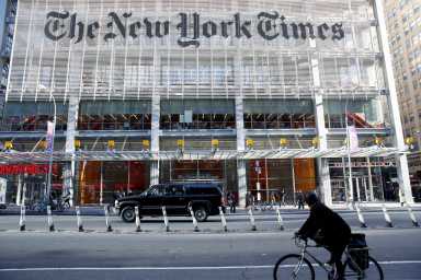 The motorcade of U.S. President-elect Donald Trump makes its way past the New York Times building after a meeting in New York