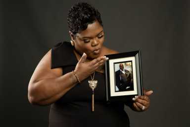 A handout image shows Devon Brumfield holding a photo of her father