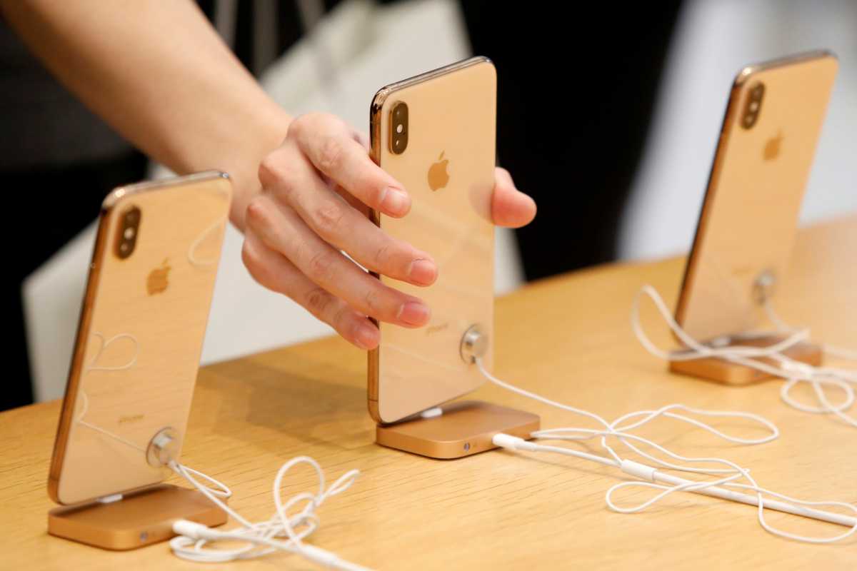 People look at  iPhones at the World Trade Center Apple Store during a Black Friday sales event in Manhattan, New York City