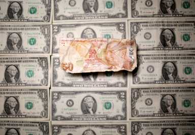Turkish Lira and Dollar banknotes are seen in this picture illustration
