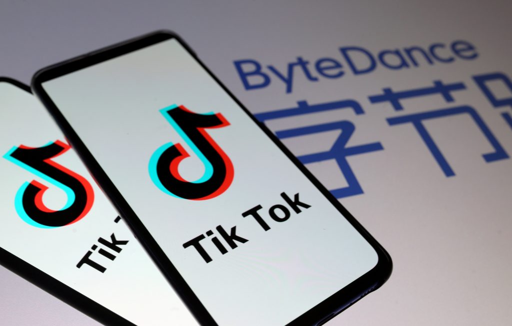 FILE PHOTO: TikTok logos are seen on smartphones in front of displayed ByteDance logo in this illustration