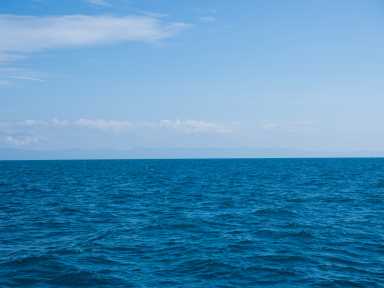 Landscape of sea horizon seascape under blue sky.