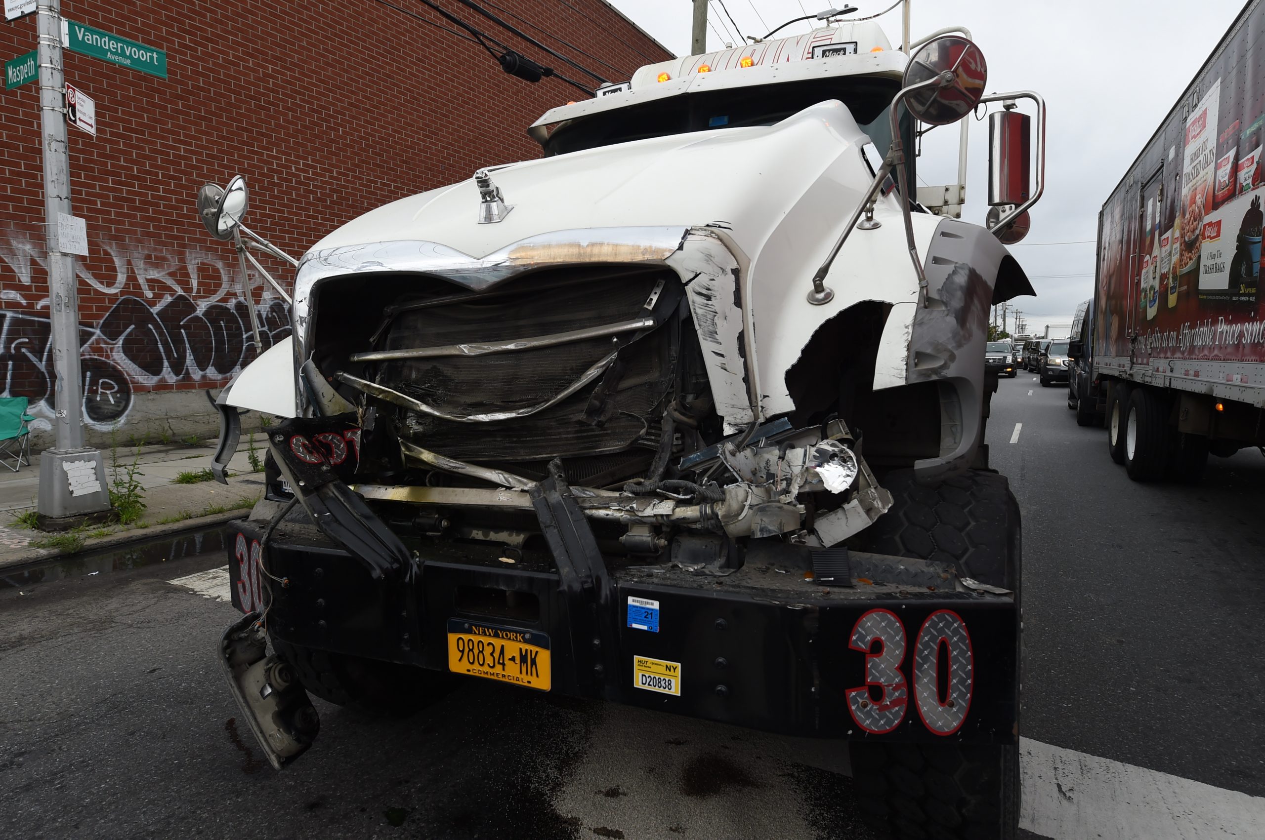 Two trucks collide in Brooklyn, causing large produce hauling truck to flip on its side 2