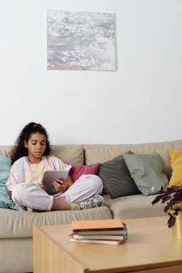 photo-of-girl-sitting-on-sofa-while-using-tablet-4144040-549×822