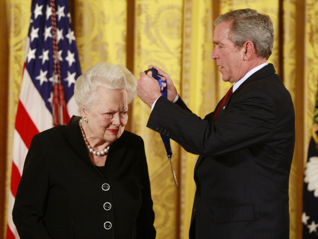 U.S. President Bush presents veteran actress Olivia de Havilland with a National Medal of Arts in Washington